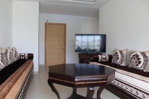 a living room with a couch and a coffee table at Paradise évasion Bord de Mer avec Piscine in Pont Blondin