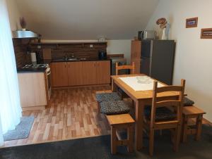 a kitchen with a table and chairs and a refrigerator at Ubytování Iris in Dolany