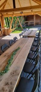 a long wooden table with chairs in a pavilion at Pod Milanem in Przemyśl