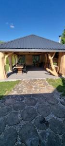 a stone patio with a building with a black roof at Pod Milanem in Przemyśl