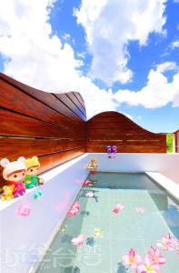 a swimming pool with toy figurines in the water at 墾丁 後灣 微風海岸海景民宿 in Checheng