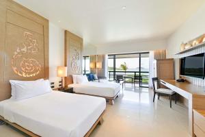 a hotel room with two beds and a table and chairs at SYLVAN Koh Chang in Ko Chang +140 photos