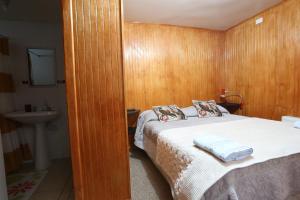 מיטה או מיטות בחדר ב-Casa Chilhué - Hostal Residencial