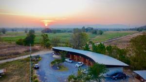 an aerial view of a building with a parking lot at JanJao Resort in Nakhon Sawan