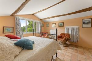 a bedroom with a bed and a table and chairs at Mas Abicou in Vézénobres +36 photos