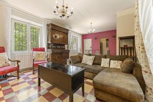 a living room with a couch and a table at Mas Abicou in Vézénobres