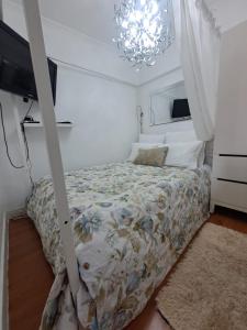 a bedroom with a bed and a chandelier at Lovehome Apartment in Lisbon +44 photos