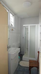 a white bathroom with a sink and a shower at Maison La Picade in Saint-Mamet +19 photos