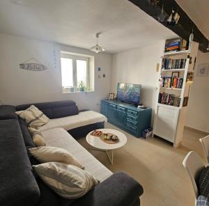 a living room with a couch and a table at Plavo bijeli svijet in Preko
