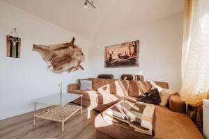 a living room with a couch and a table at Ferienwohnung Altes Zollhaus in Ering