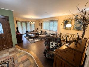 a living room with a couch and a table at Peaceful Retreat - Kefalos Stay with Patio views & gym in Kefalos