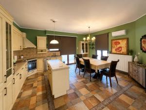 a kitchen with a table and chairs in it at Peaceful Retreat - Kefalos Stay with Patio views & gym in Kefalos