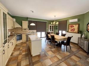 a large kitchen with a table and chairs in it at Peaceful Retreat - Kefalos Stay with Patio views & gym in Kefalos +30 photos