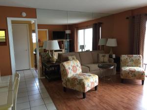 a living room with a couch and two chairs at Crescent Arms Condominiums in Siesta Key