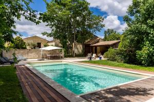 a swimming pool in the backyard of a house at La Ferme - Château Le Noble in Saint-Germain-du-Puch