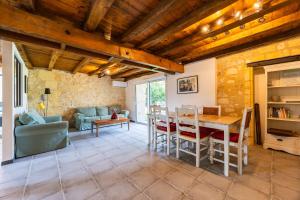 a living room with a table and chairs at La Ferme - Château Le Noble in Saint-Germain-du-Puch