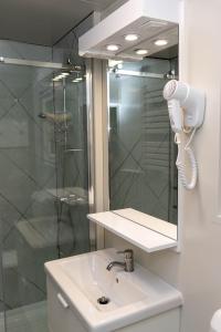 a bathroom with a shower and a sink and a mirror at Igal Thermal Camping in Igal