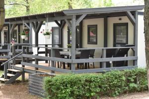 a house with awning and benches in front at Igal Thermal Camping in Igal
