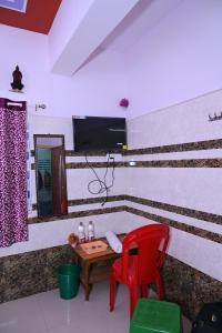 a room with a table and two chairs and a mirror at Gitanjali Lodge in Rāmagiri Udayagiri