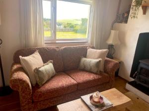 a living room with a couch and a window at Seaview in Duneen +17 photos
