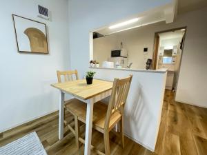 a kitchen and dining room with a table and chairs at エムズ千歳幸町2 in Chitose
