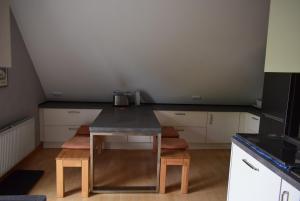a small kitchen with a table in a room at FeWo Vobbe in Dänischenhagen