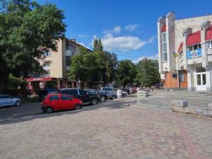 a street with cars parked on the side of the road at Luxury 2 Rooms Apartments in Center by Green House in Poltava