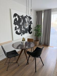 a dining room with a table and two chairs at Ferienwohnungen in Borkheide in Borkheide