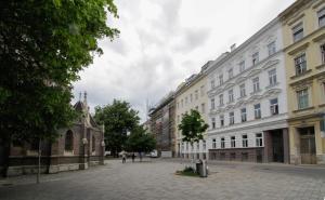 an empty street in a city with buildings at Indigo am Gürtel in Vienna