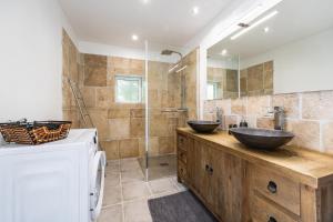 a bathroom with two sinks and a shower at La Ferme - Château Le Noble in Saint-Germain-du-Puch +26 photos