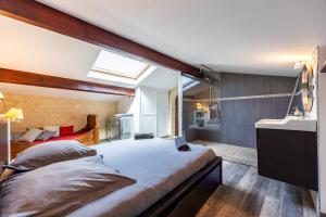 a bedroom with a large bed and a sink at Le Loft - Château Le Noble in Saint-Germain-du-Puch +19 photos
