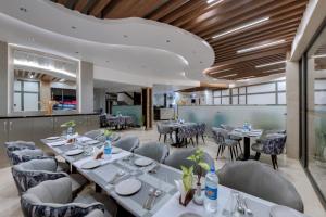 a dining room with tables and chairs at Click Sunburry Hotel Katra in Katra