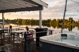 a hot tub on a dock next to the water at Koivuranta Igloos in Oulu