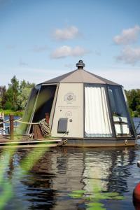 a small boat sitting on the water at Koivuranta Igloos in Oulu