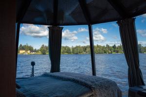 a bed on a boat in a body of water at Koivuranta Igloos in Oulu +12 photos