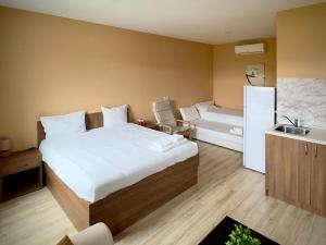a bedroom with a large bed and a sink at AirportStay bg - free shuttle and own parking in Sofia
