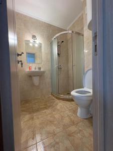 a bathroom with a shower and a toilet and a sink at Равда Аполон 9 in Nesebar