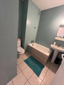a bathroom with a tub and a toilet and a sink at Petite Case cade in Sainte-Marie