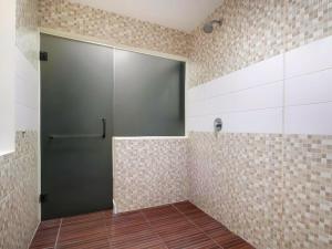 a shower stall with a sliding door in a bathroom at Guntur Hotel Bali in Ketewel +27 photos