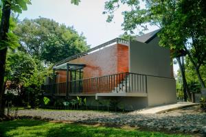 a house with a staircase on the side of it at Tuju Villa Hamparan Syariah in Ciledug