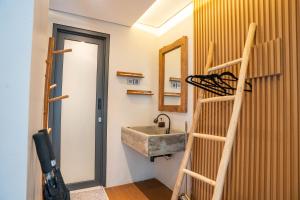 a bathroom with a sink and a ladder next to a mirror at Tuju Villa Hamparan Syariah in Ciledug +43 photos