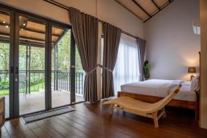 a bedroom with a bed and a large window at Tuju Villa Hamparan Syariah in Ciledug