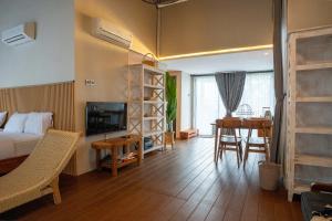 a bedroom with a bed and a table and a desk at Tuju Villa Hamparan Syariah in Ciledug