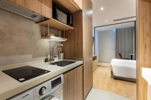 a kitchen with a sink and a stove in a room at HOMES Stay MyeongDong in Seoul +58 photos