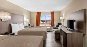 a hotel room with two beds and a flat screen tv at Econo Lodge Willowbrook in Burr Ridge +132 photos