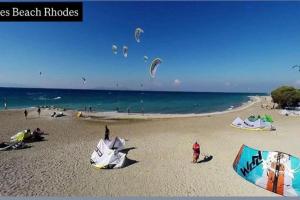 a group of people on a beach flying kites at Villa Nostra Airport Pick-Up Service in Soroni