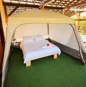 a tent with a bed in the middle of it at Marina Park in Vama Veche +24 photos