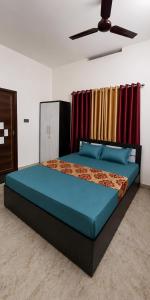 a bedroom with a bed and a ceiling fan at Varkalite homestay in Varkala