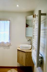 a bathroom with a sink and a mirror at Chalet l'Escale du Cèdre in Rivières +30 photos