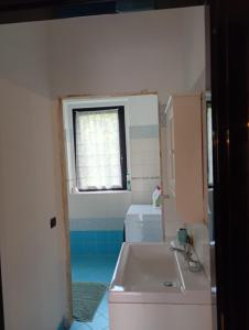 a bathroom with a tub and a sink and a window at Bright apartment between Como and Milan in Lurago Marinone +11 photos